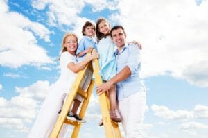 Cheerful family standing on the ladder.