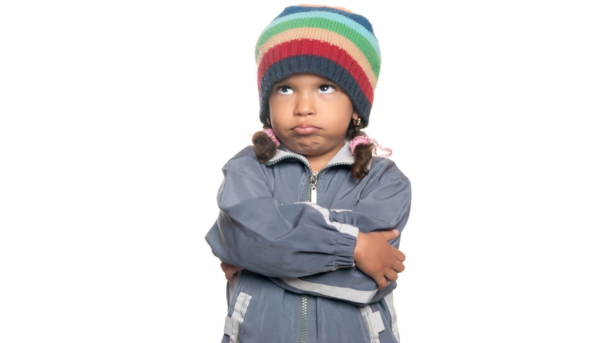 a young girl wearing a hat and jacket