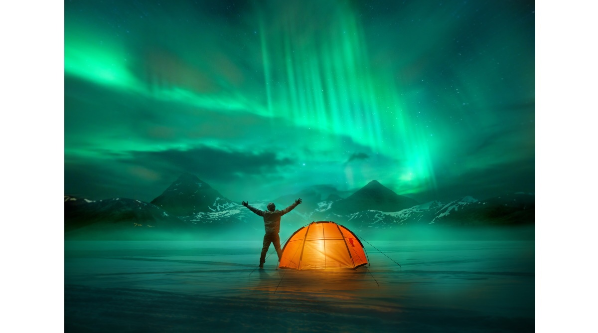 a person standing in front of a tent in the middle of a snowy landscape