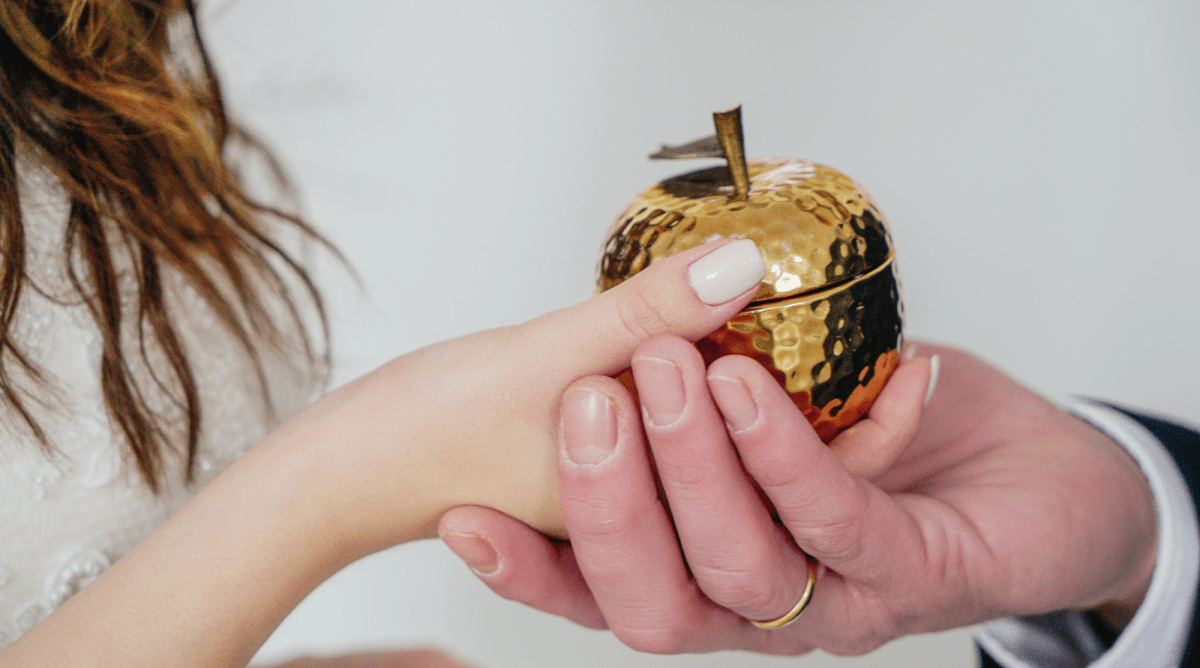 a person holding a gold object