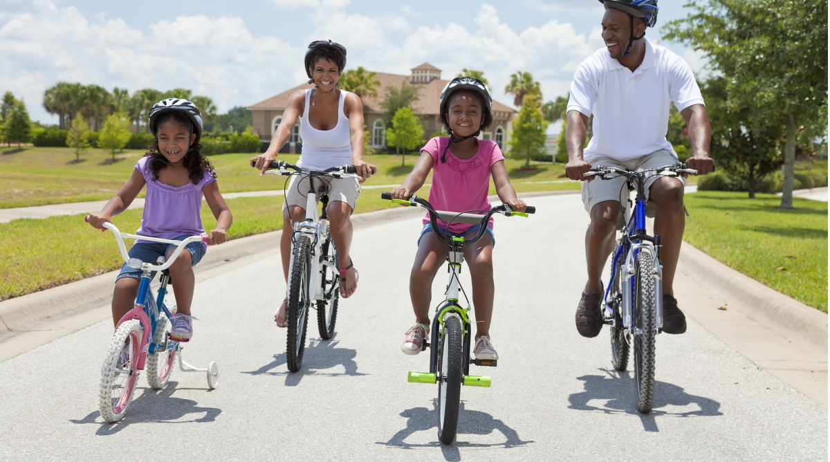 a family riding bikes on a street